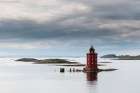 Kjeungskjaer lighthouse sits on a small island in the glacial waters of Bjugnfjorden Norway Art Print